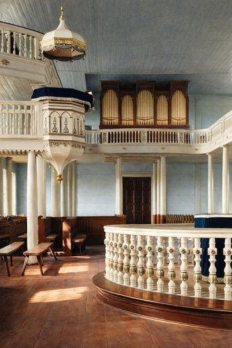 A magnificent side view of the church interior showing the raised pulpit with a distinguished canopy and the huge pip…