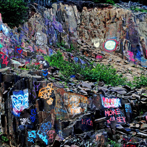 Colorful graffiti along the escarpment leading to Dark Harbour on Grand Manan Island, New Brunswick, Canada