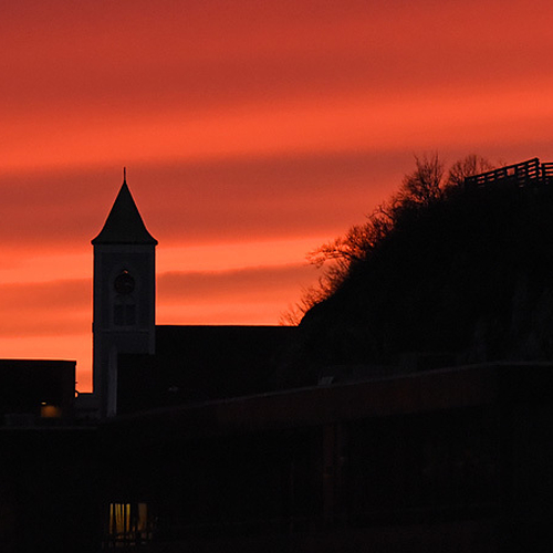 A spectacular sunset silhouettes the North End of Saint John, NB.