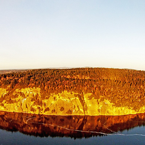 An aerial composition of Long Island and with a glazed over Kennebecasis River providing a mirror reflection. Taken f…