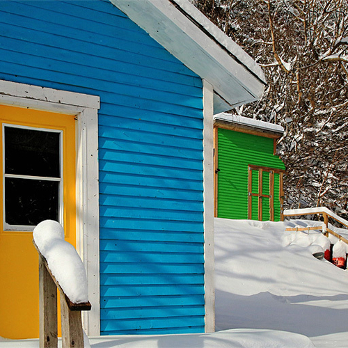 Polychromatic chalets opposite the wharf in St. Martins, New Brunswick.