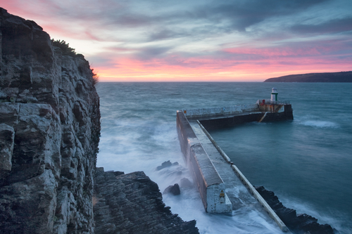 Laxey Breakwater at sunrise and high tide.