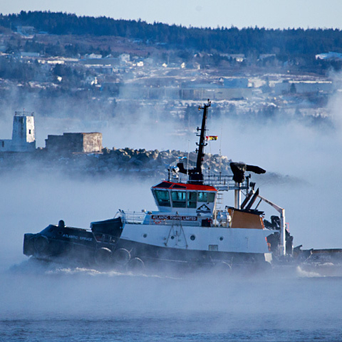 A tug boat, the Atlantic Spruce, steams past the Courtenay Bay Breakwater Battery. The concrete Battery Observation…
