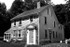 cape house with wooden door [b&w]