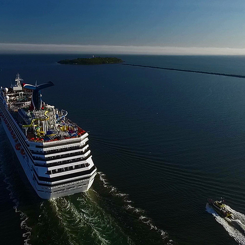 With a view of historic Partridge Island in the background, the Carnival Sunshine (& pilot escort) makes her way out…