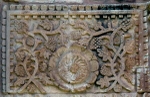 Bottom tier, sculpture niche relief (far left)