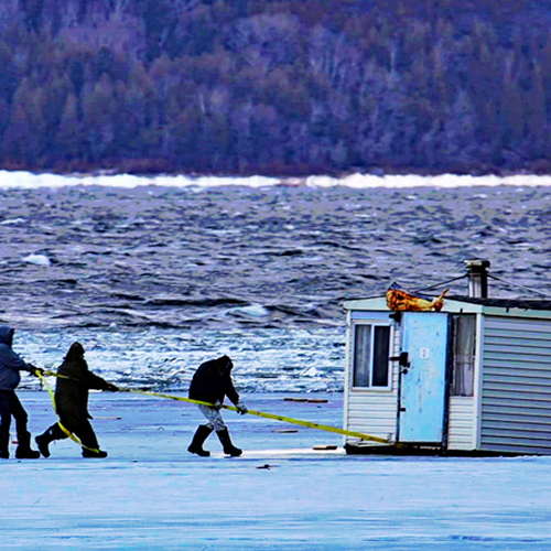 Members of the Renforth Ice Fishing Village in Rothesay, New Brunswick attempt to save a stranded ice shack caught up…