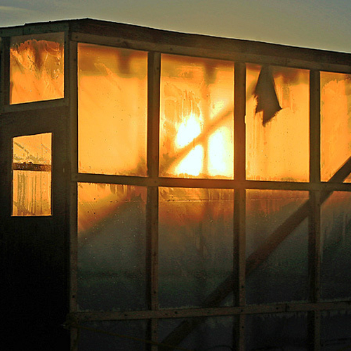 Translucent ice shack filtering the last rays of sunlight at the end of the day.