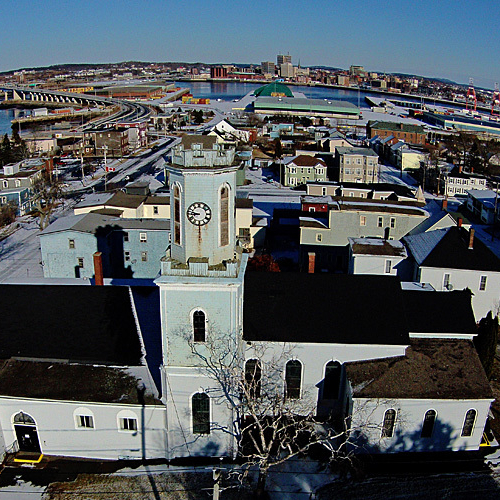 An aerial view of St. George's Anglican Church showing the Harbour Bridge and Uptown Saint John in the background. Th…
