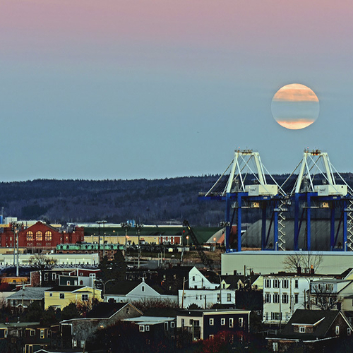 Full super moonrise over the lower westside of Saint John, New Brunswick looking toward the Potash terminal and Court…