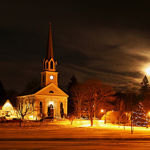Rothesay Common with St. Paul's Anglican Church and a full moon in the background.