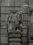 Façade, second story, left finial archangel