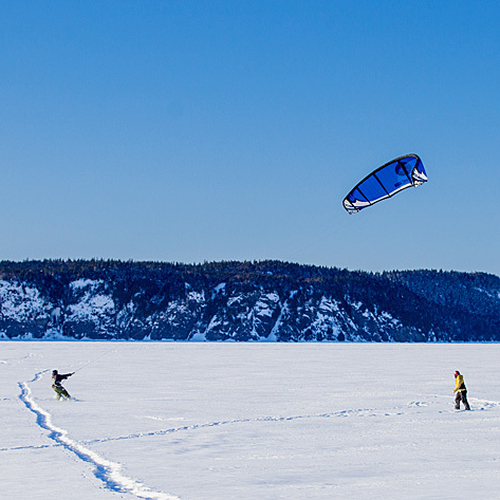 Snowkiters prepare for an afternoon of activity amid a backdrop of a snowcapped Long Island in Rothesay, New Brunswic…