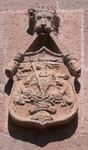 Façade, upper story escutcheon (left)