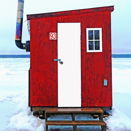 A red ice shack with stove pipe at Renforth Ice Fishing Village in Rothesay, New Brunswick, Canada.