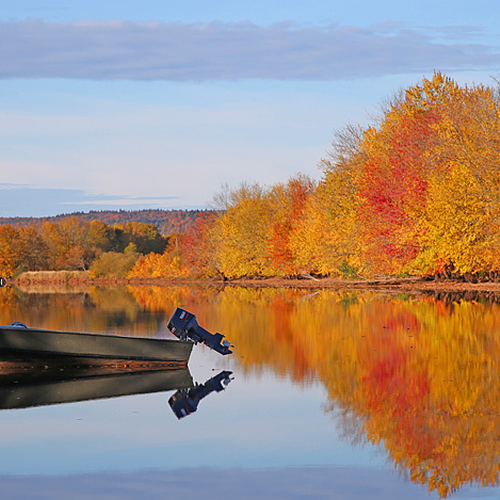 Boat and autumn reflections along the Kennebecasis River @ Hampton, New Brunswick, Canada.