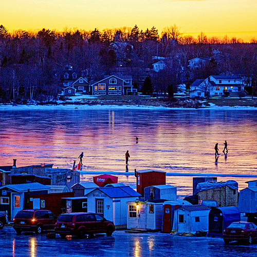Ice-reflected twilight hues paint a colorful atmosphere around this seasonal village along the banks of the Kennebeca…
