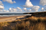 Holywell Bay Beach in early morning golden light