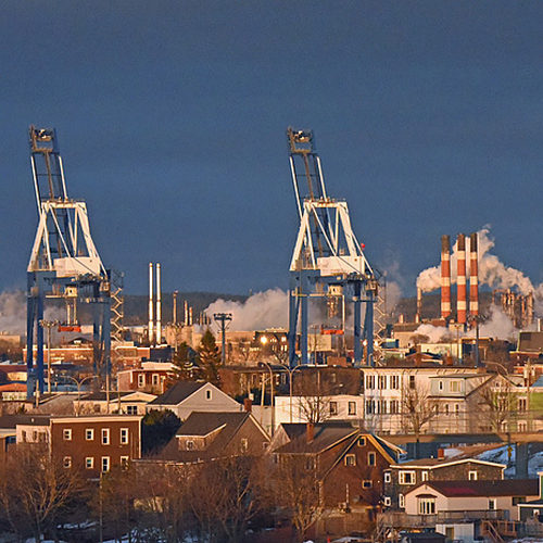 Looking eastward towards the Port of Saint John, Courtenay Bay, and the Irving Refinery with century buildings of the…