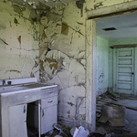 Kitchen sink and green door.