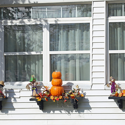Colorful gourds replace flowers under windows as summer turns into autumn.