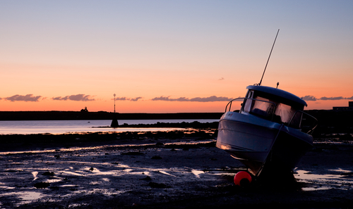 October Daybreak at Derby Haven. Lovely clear sky and orange glow, with condensation on the boat windows and a lone d…