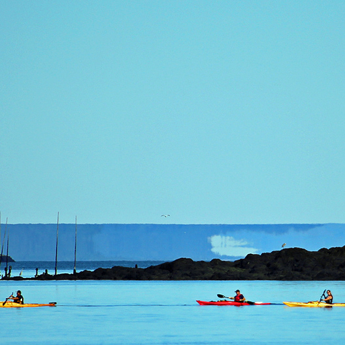 Sea Kayaking near Campobello Island. The landmass visible directly behind the lagging 2 kayaks is a mirage or fata mo…