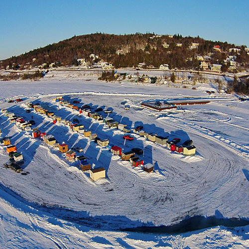 The long shadows of late afternoon start to encroach on the ice huts situated along the Kennebecasis River @ Renforth…