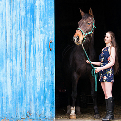 young lady with bay horse in blue doorway