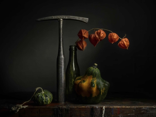 Still-life with Chipping Hammer. A still-life medley of tools, vintage glassware, flowers and fruit. Lit with diffuse…