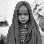 Child in blanket, Delhi, India