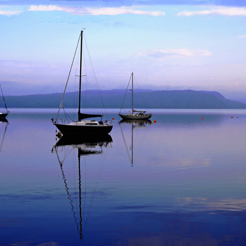 sailboats at sunrise along the Kennenbecasis river at Renforth, New Brunswick