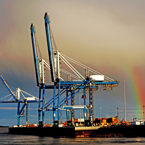 A shard of rainbow pokes through storm clouds over the Port of Saint John in New Brunswick Canada
