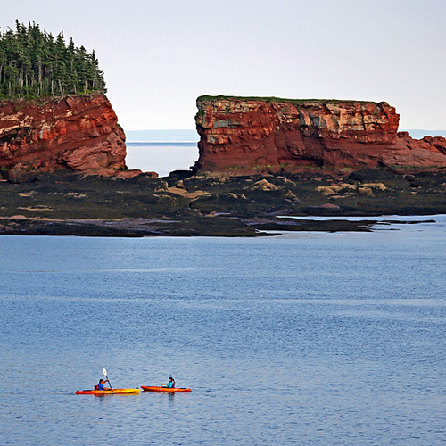 Kayaks converge off Duck Pond Beach and with Split Rock, an age old rock formation carved and formed by the highest t…