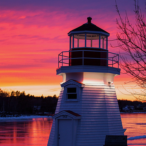 A frozen over Renforth Cove reflects the hues of another brilliant sunset and highlights the outline & features of th…
