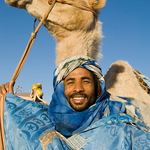 Smiling Man with camel, Morocco