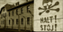 Auschwitz Halt sign and building sepia