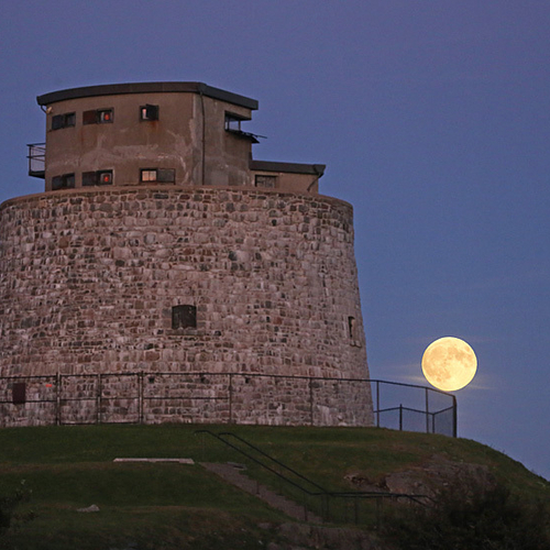 The Super Blood Moon appears over the protective fencing encircling Martello Tower in Saint John, NB, Canada.