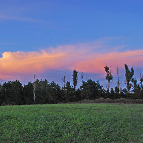 Just after sunset, high altitude clouds remain illuminated from the sun's rays.