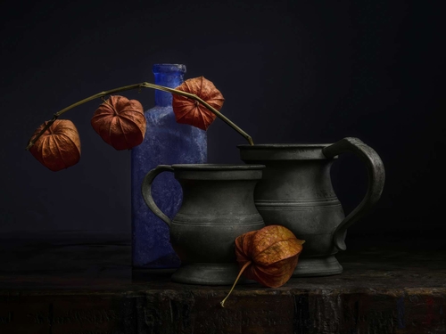 Physalis Flowers. Light-painted still-life featuring Physalis (Chinese Lantern) flowers, a blue bottle and small pewt…