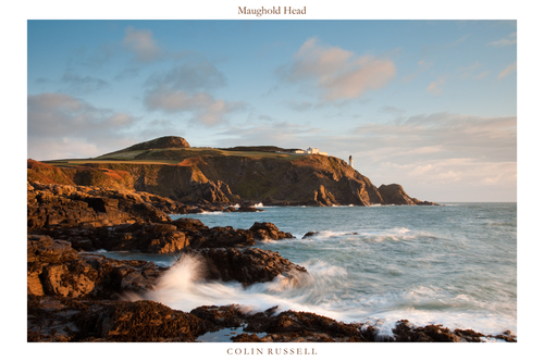 Early morning sunlight catching Maughold Head and lighthouse.