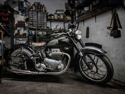 Ariel Square Four. Vintage Ariel motorcycle, photographed in the owner's workshop. Lit with diffused torchlight.