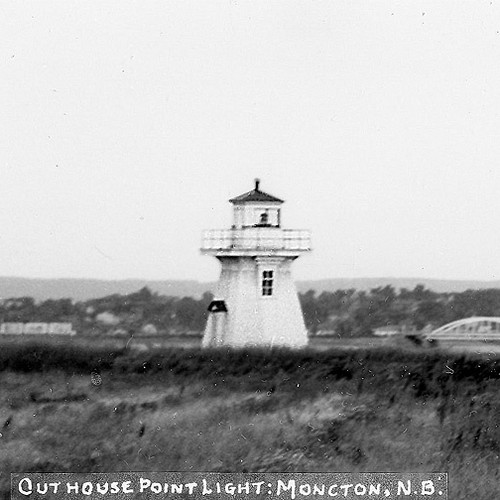 A rare early glimpse of the Outhouse Point Lighthouse in Moncton. Notice the cars parked beside, and the bridge in th…