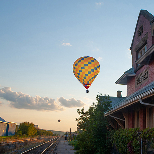 Balloons float along the skyline at sunset in downtown Sussex, New Brunswick