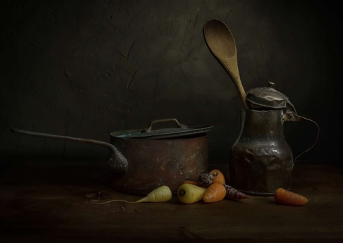 Last of the Carrot Crop. Light-painted still-life photograph featuring garden-grown carrots and vintage kitchen utens…