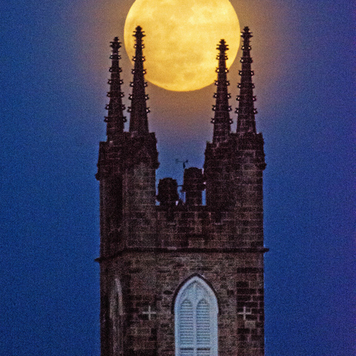 A portrait POV of the historic Stone Church with the full 'Worm Moon' - soon to be eclipsed - rising up behind the st…