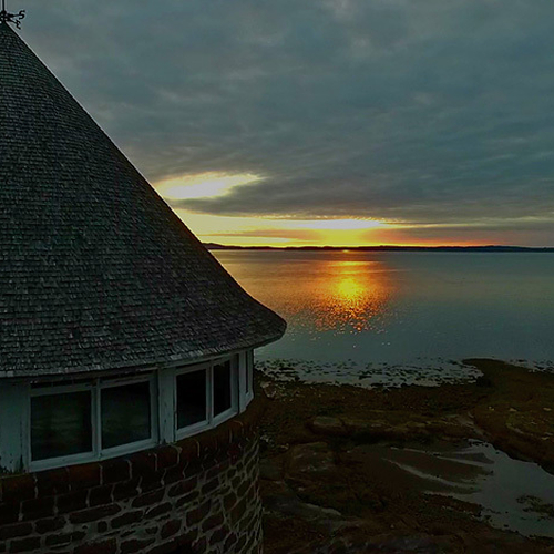 Early morning sun reflecting off Passamaquoddy Bay from a drone pov.
