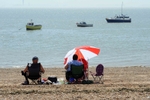 people on beach looking out to sea