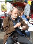 Man eating by food stall