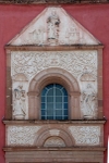 Façade, main portal entablature, choir loft window & pediment